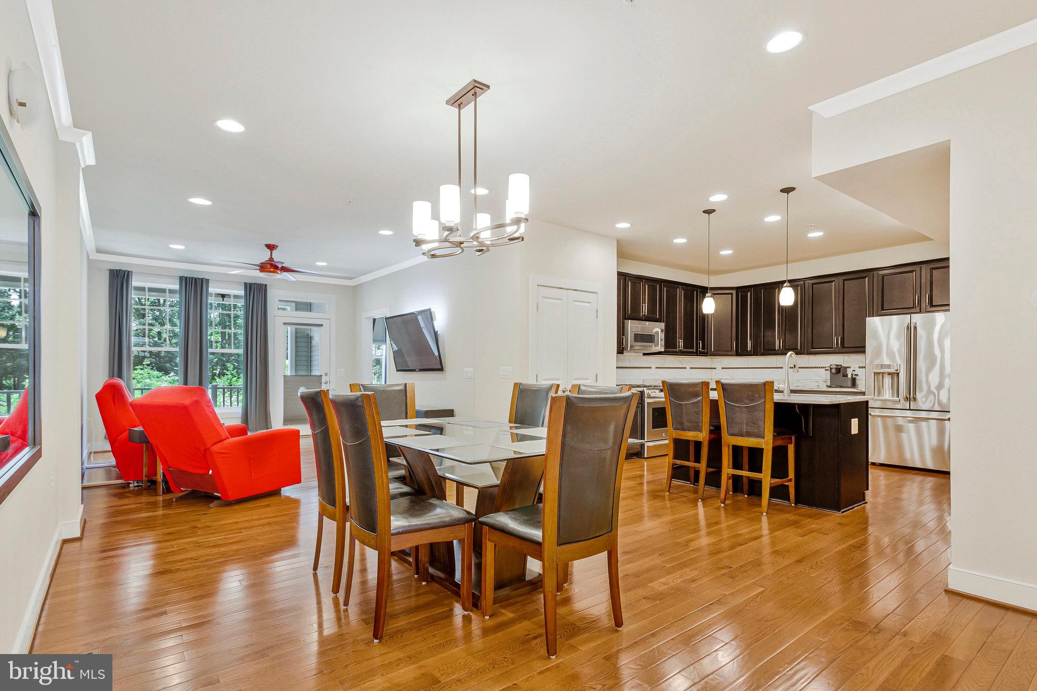 9726 Knowledge Drive Laurel, MD 20723 - Photo 3 of 54 a dining room with furniture a chandelier and kitchen view