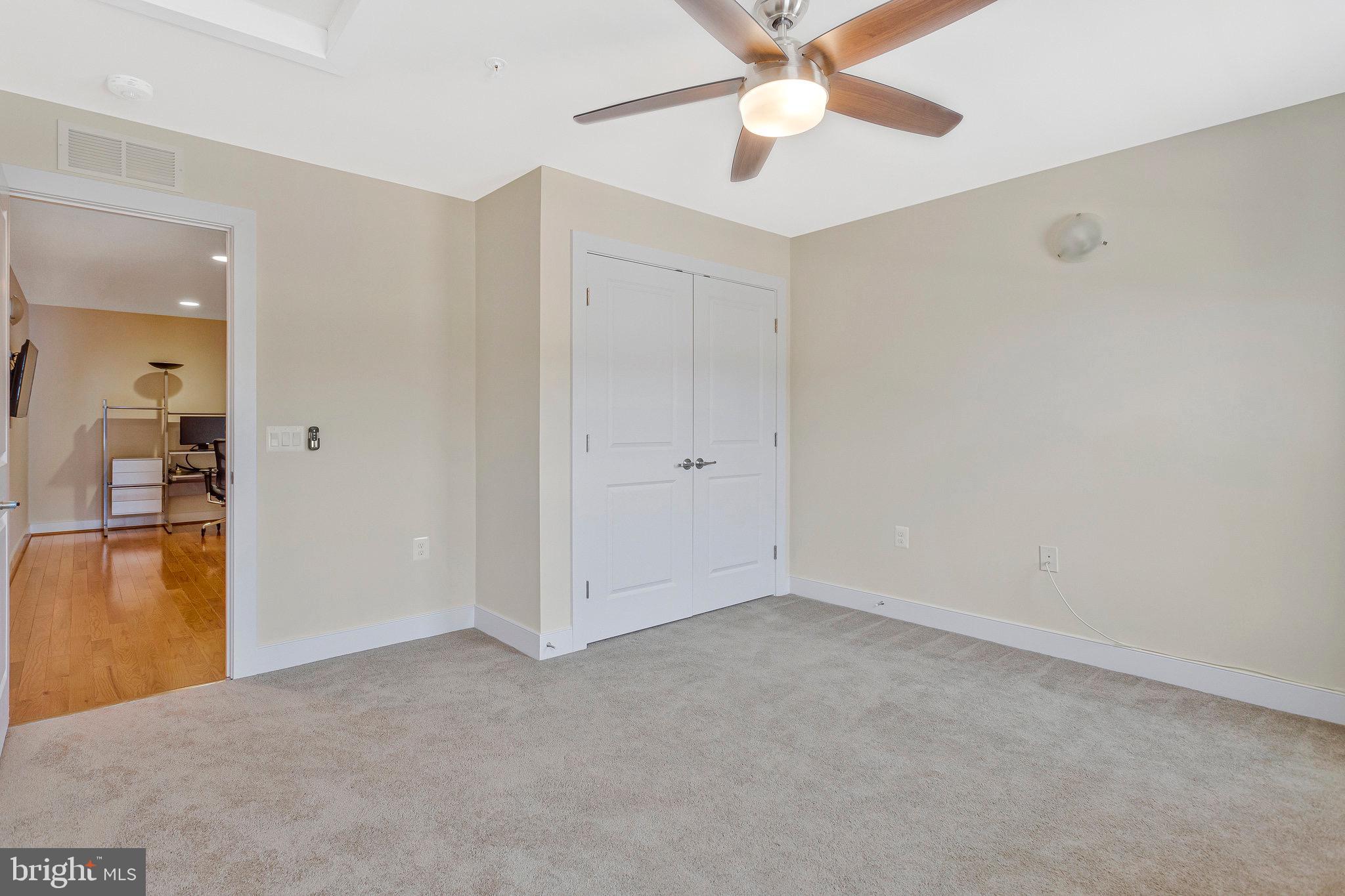 9726 Knowledge Drive Laurel, MD 20723 - Photo 31 of 54 an empty room with closet and a ceiling fan