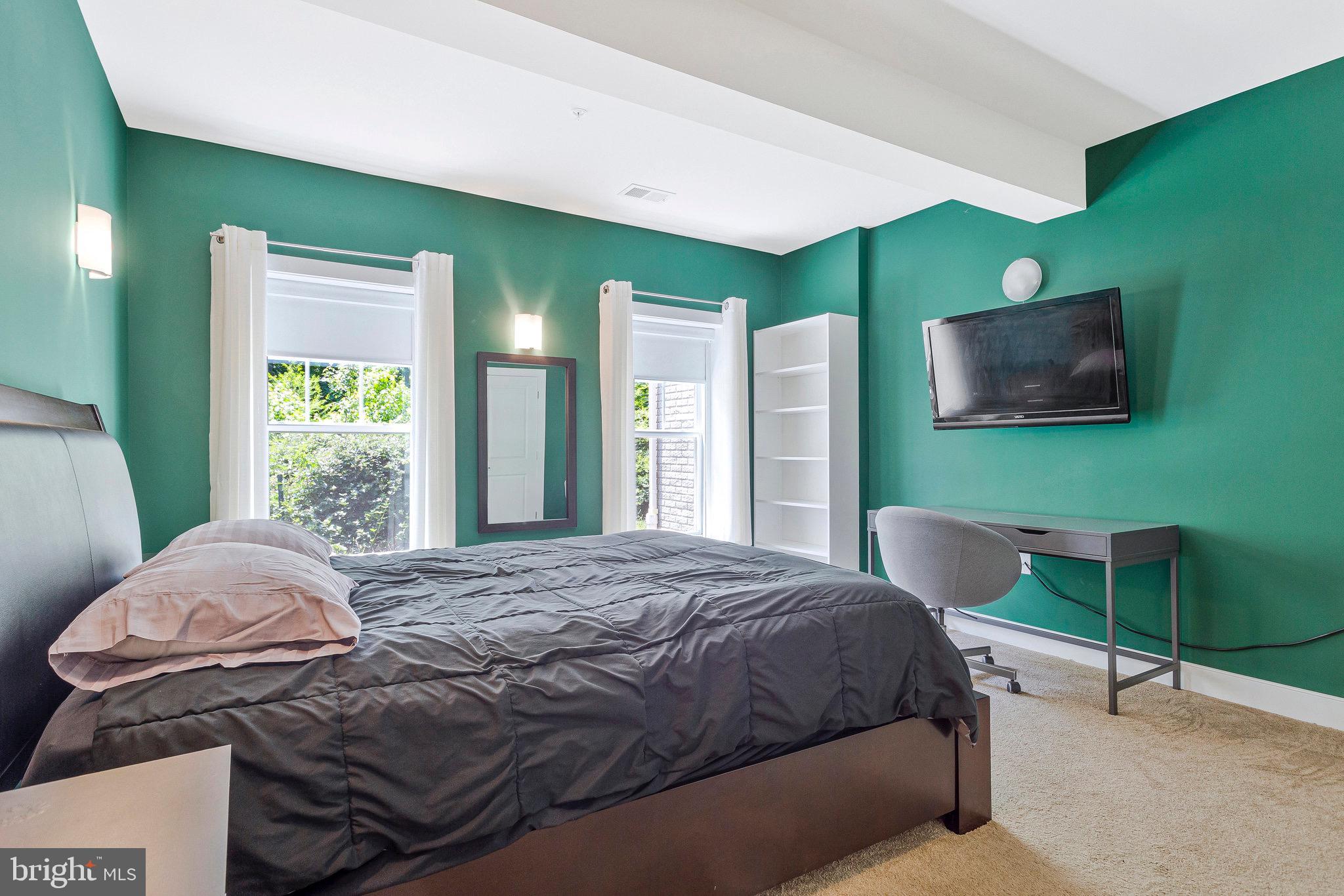 9726 Knowledge Drive Laurel, MD 20723 - Photo 41 of 54 a bedroom with a bed and a flat screen tv