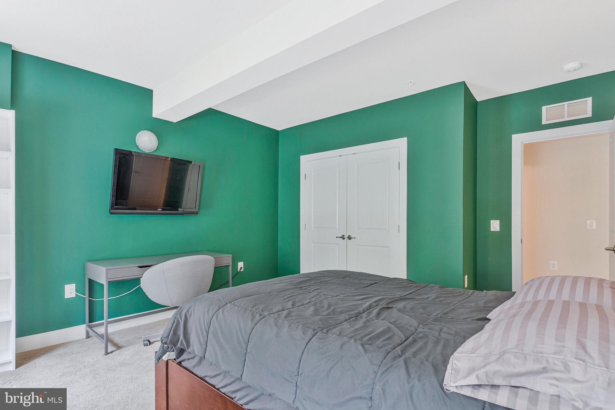 9726 Knowledge Drive Laurel, MD 20723 - Photo 43 of 54 a bedroom with a bed and a flat screen tv