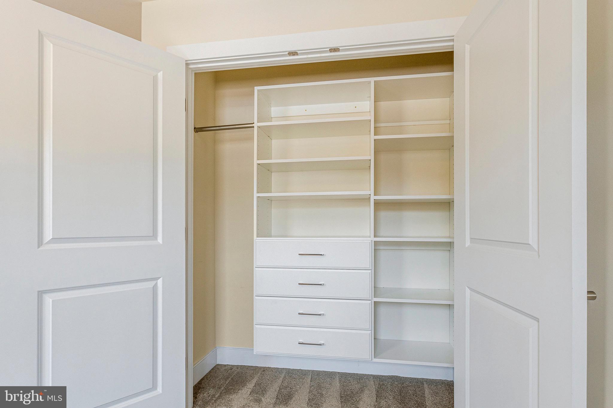 9726 Knowledge Drive Laurel, MD 20723 - Photo 45 of 54 a view of walk in closet with empty racks