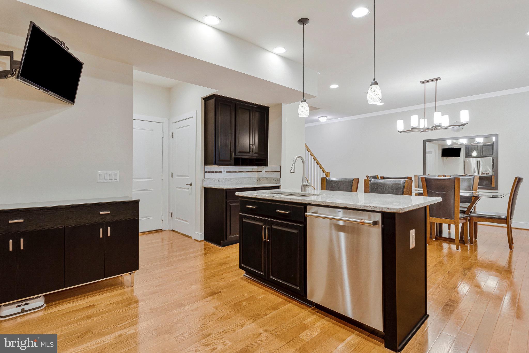 9726 Knowledge Drive Laurel, MD 20723 - Photo 8 of 54 a kitchen with kitchen island granite countertop stainless steel appliances and view of living room