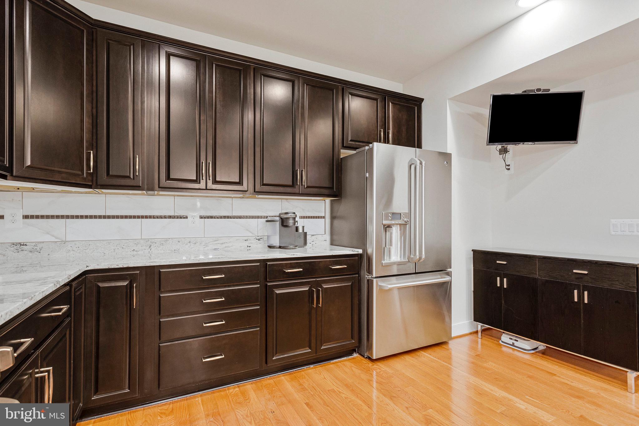 9726 Knowledge Drive Laurel, MD 20723 - Photo 9 of 54 a kitchen with stainless steel appliances granite countertop a refrigerator and a stove top oven