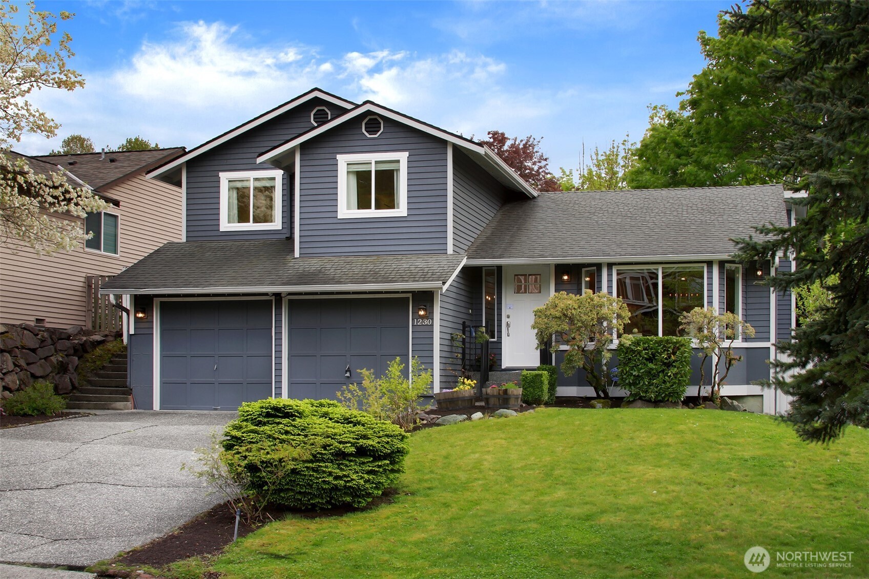 1230 222nd Place Southwest Bothell, WA 98021 - Photo 1 of 28 a front view of a house with a yard and porch