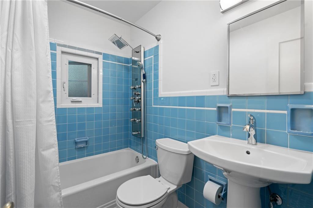 119 Byron Road Pittsburgh, PA 15237 - Photo 22 of 36 Blue vintage tile bathroom with updated sink and a spa like shower with multiple shower heads.