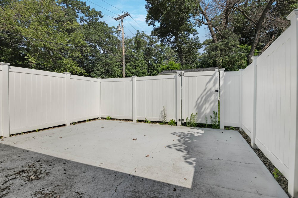 924 Superior Street Spooner, WI 54801 - Photo 10 of 39 Beautiful courtyard with privacy fence just off of the garage.