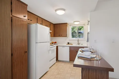 a white refrigerator freezer sitting inside of a kitchen