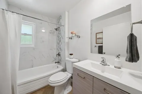 a bathroom with a sink a toilet and a large mirror