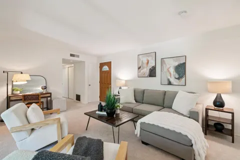 a living room with furniture and a table