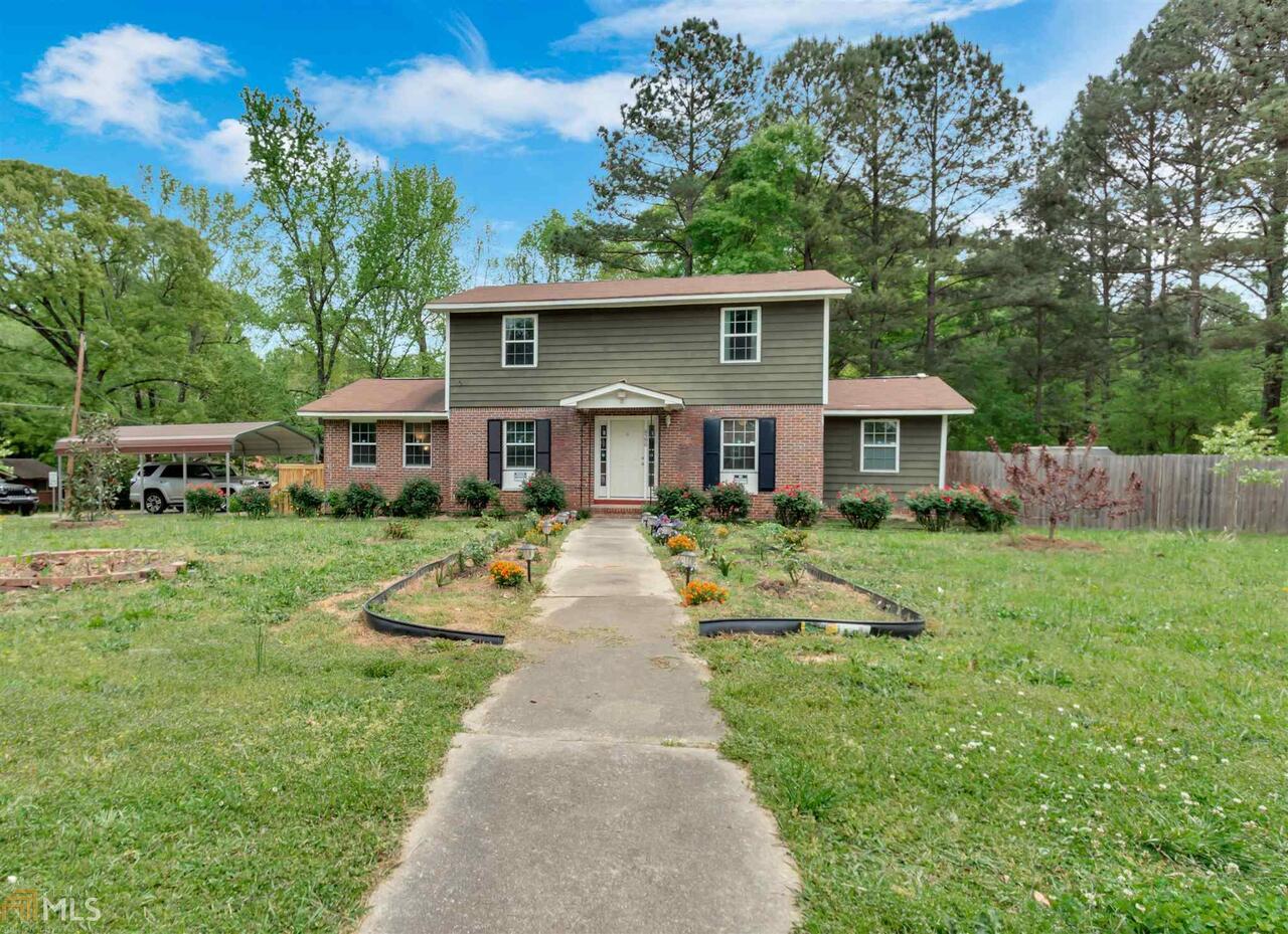 6596 Maddox Road Morrow, GA 30260 - Photo 1 of 1 a front view of house with yard and green space