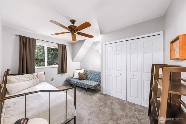 a bathroom with a granite countertop sink toilet and a mirror