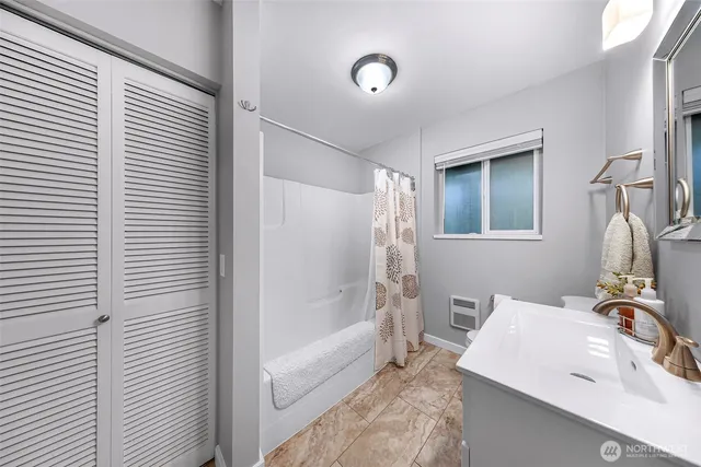 a living room with furniture a flat screen tv and kitchen view