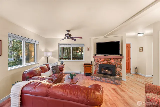 a living room with furniture a fireplace and a flat screen tv