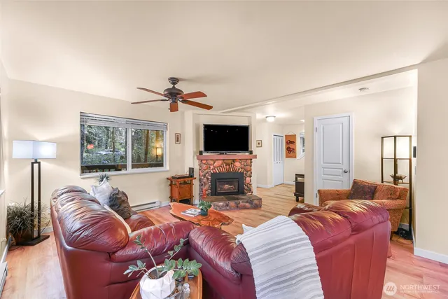 a living room with furniture a flat screen tv and a fireplace