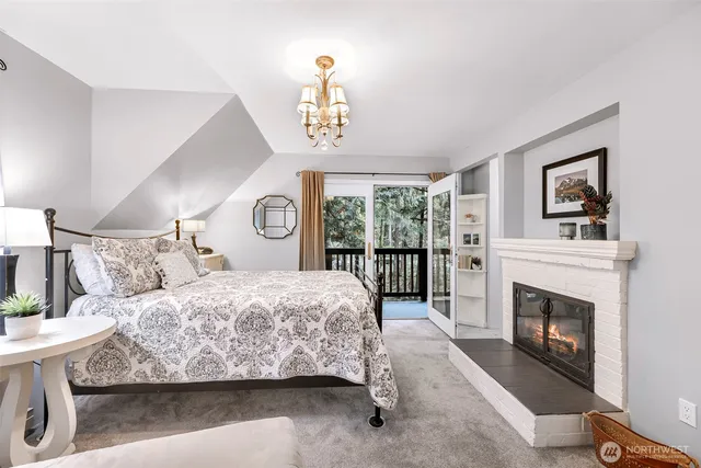 a bedroom with a bed and a fireplace