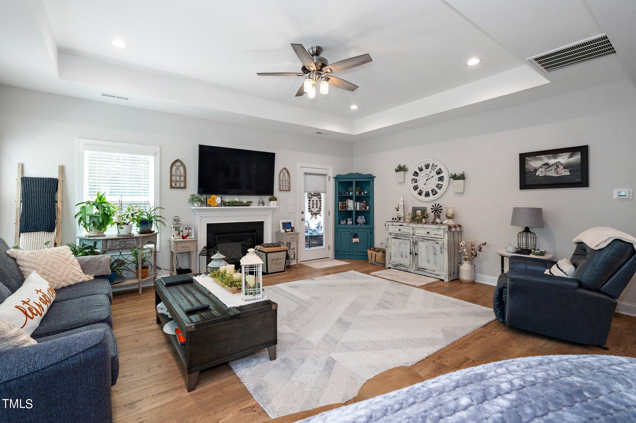 204 Stephens Timberline View Clayton, NC 27520 - Photo 14 of 43 a living room with furniture a flat screen tv and a fireplace