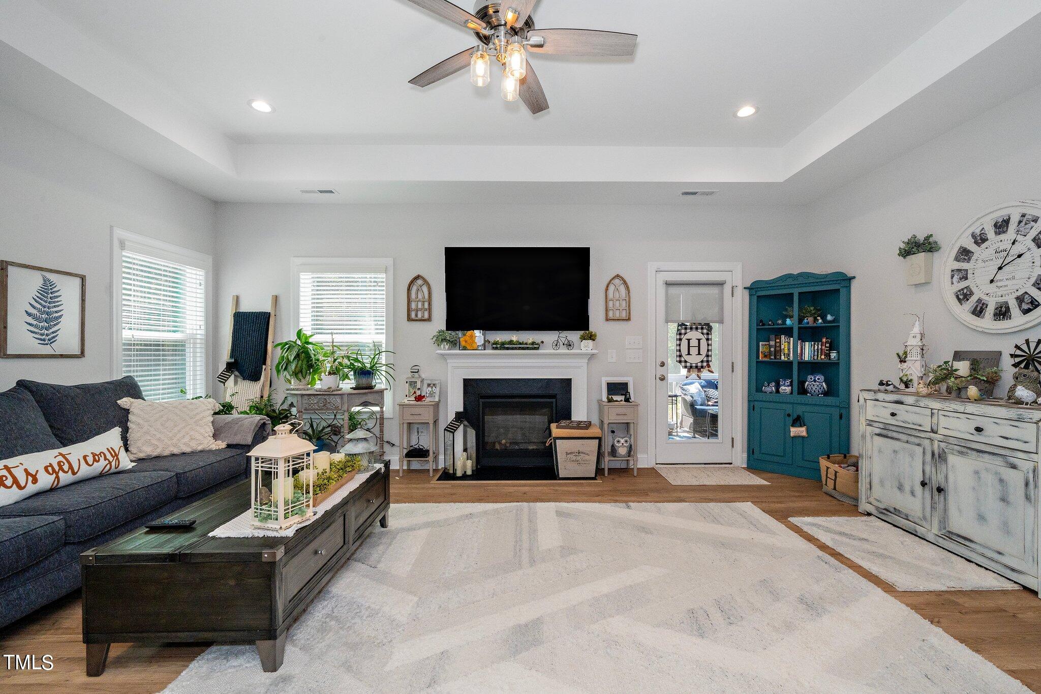 204 Stephens Timberline View Clayton, NC 27520 - Photo 15 of 43 a living room with furniture a fireplace and a flat screen tv