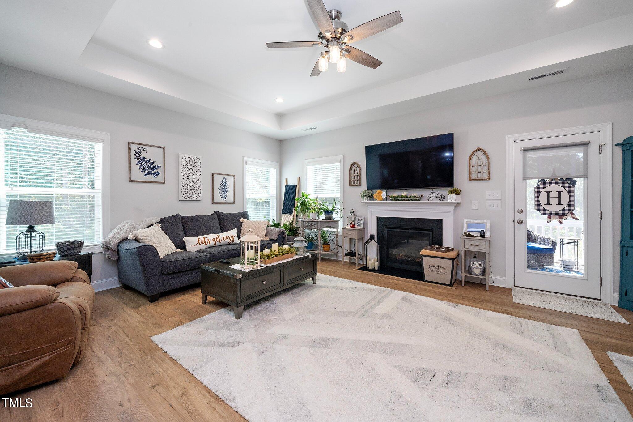 204 Stephens Timberline View Clayton, NC 27520 - Photo 16 of 43 a living room with furniture a fireplace and a flat screen tv