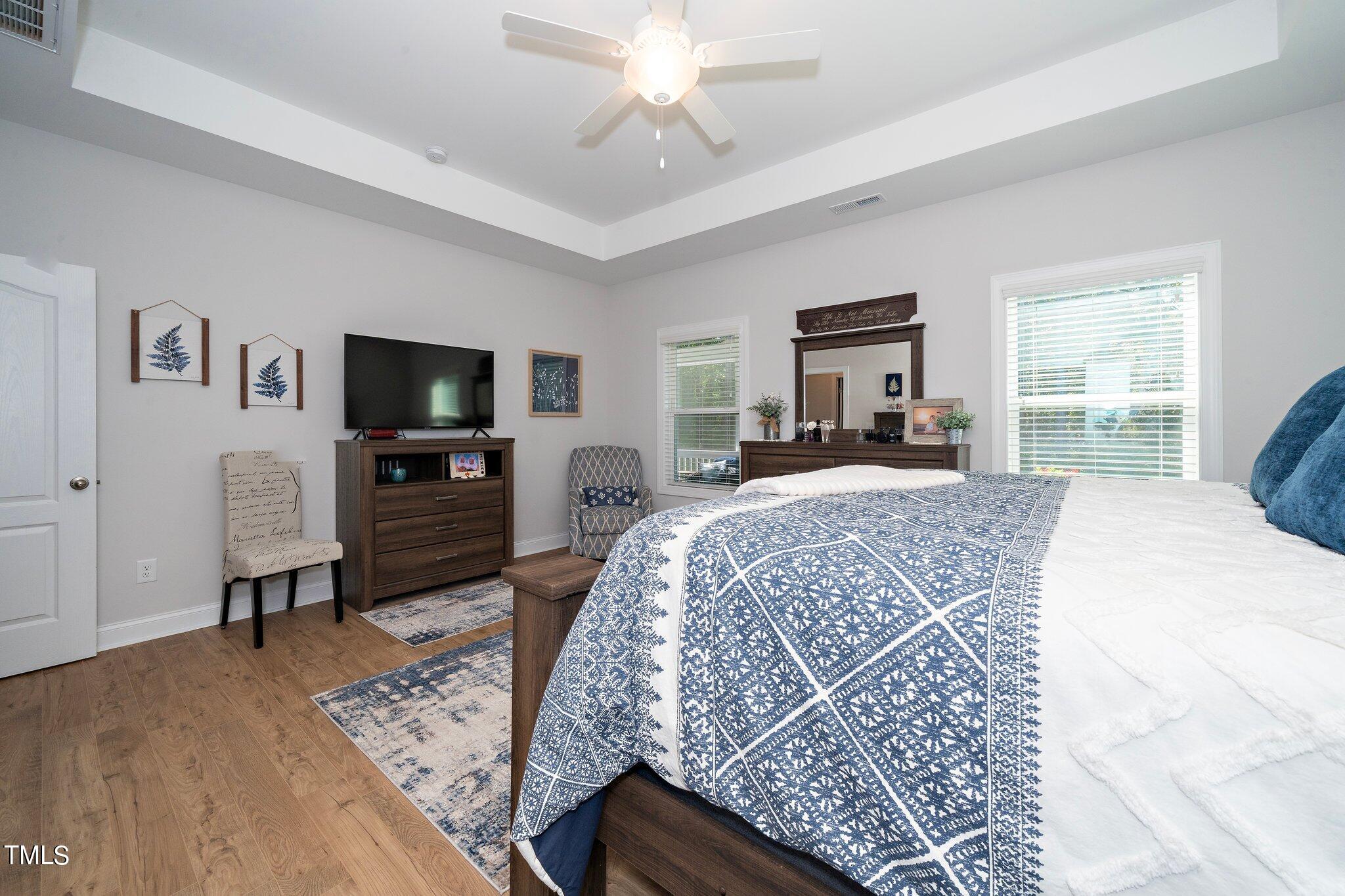 204 Stephens Timberline View Clayton, NC 27520 - Photo 18 of 43 a spacious bedroom with a bed and a flat screen television