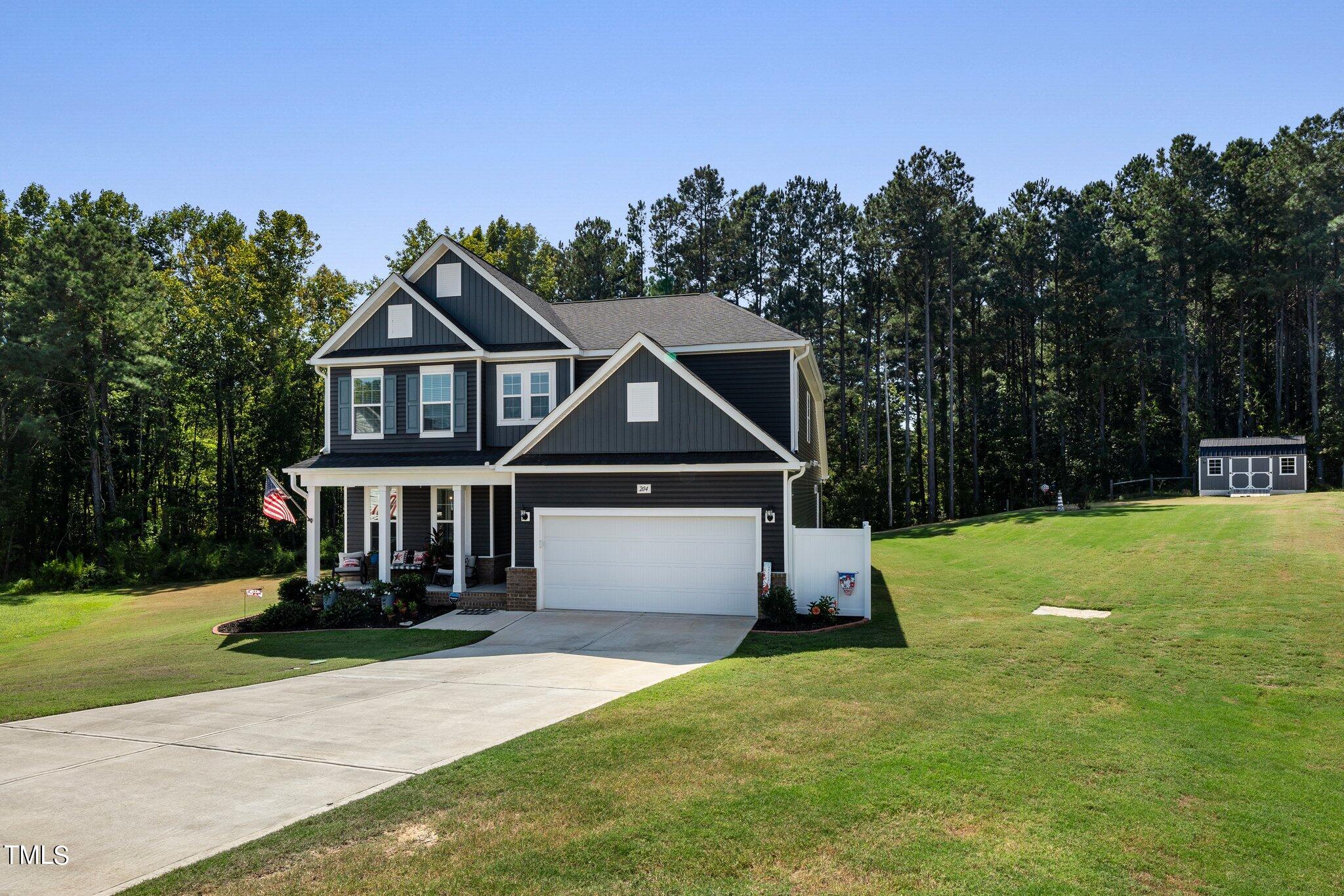 204 Stephens Timberline View Clayton, NC 27520 - Photo 2 of 43 a front view of a house with a yard
