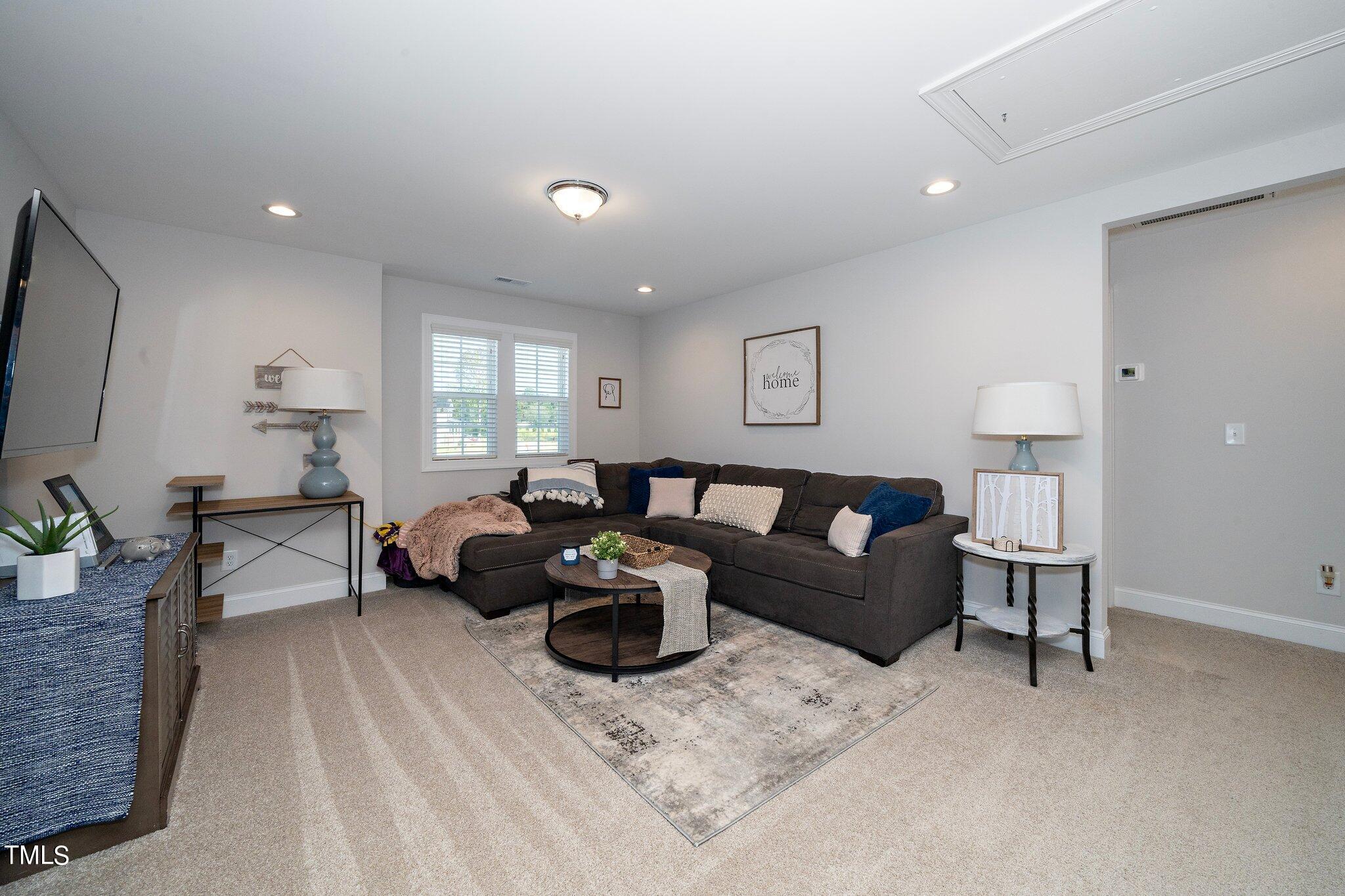 204 Stephens Timberline View Clayton, NC 27520 - Photo 26 of 43 a living room with furniture and a flat screen tv