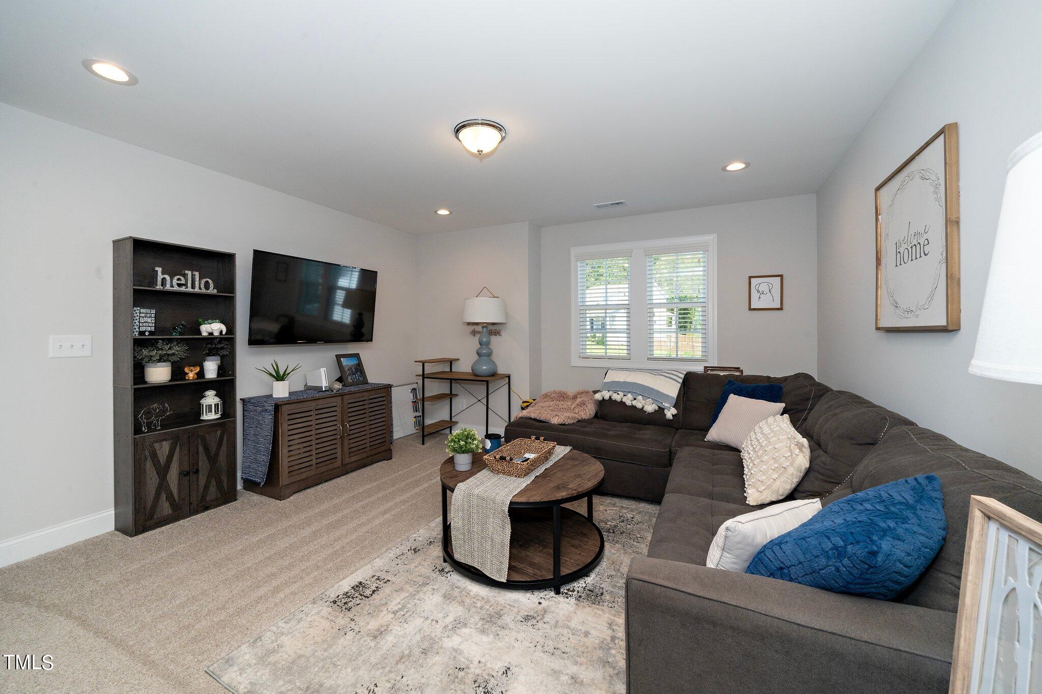 204 Stephens Timberline View Clayton, NC 27520 - Photo 27 of 43 a living room with furniture and a flat screen tv