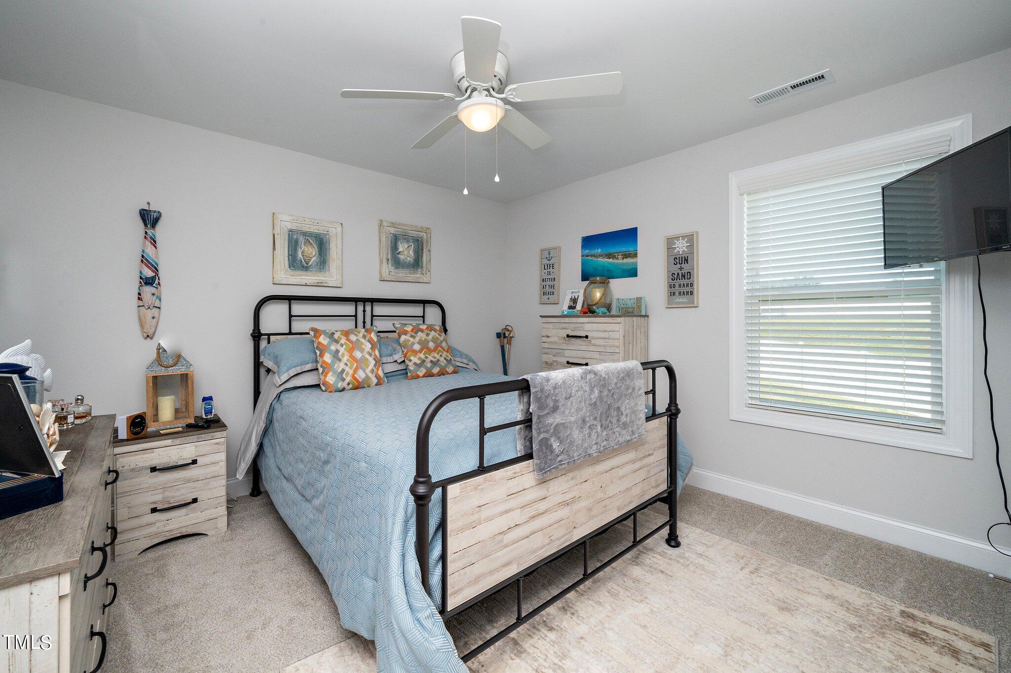 204 Stephens Timberline View Clayton, NC 27520 - Photo 29 of 43 a bedroom with a bed and a chandelier