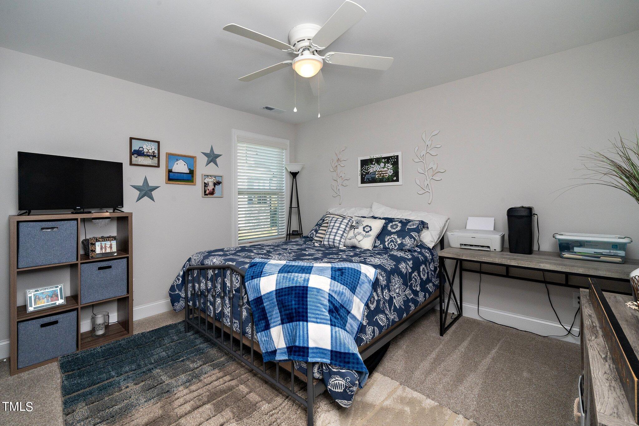 204 Stephens Timberline View Clayton, NC 27520 - Photo 30 of 43 a bedroom with a bed and a flat screen tv