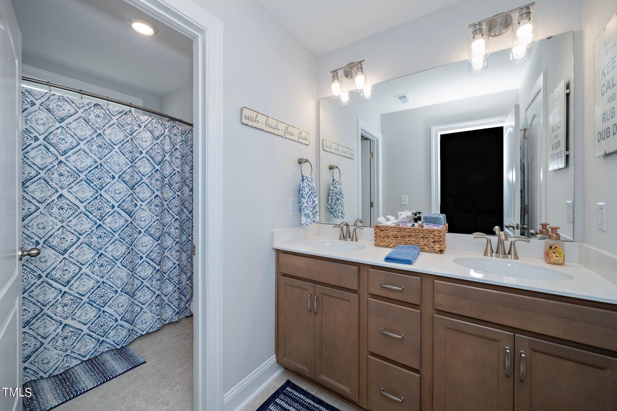 204 Stephens Timberline View Clayton, NC 27520 - Photo 32 of 43 a bathroom with a double vanity sink mirror and double