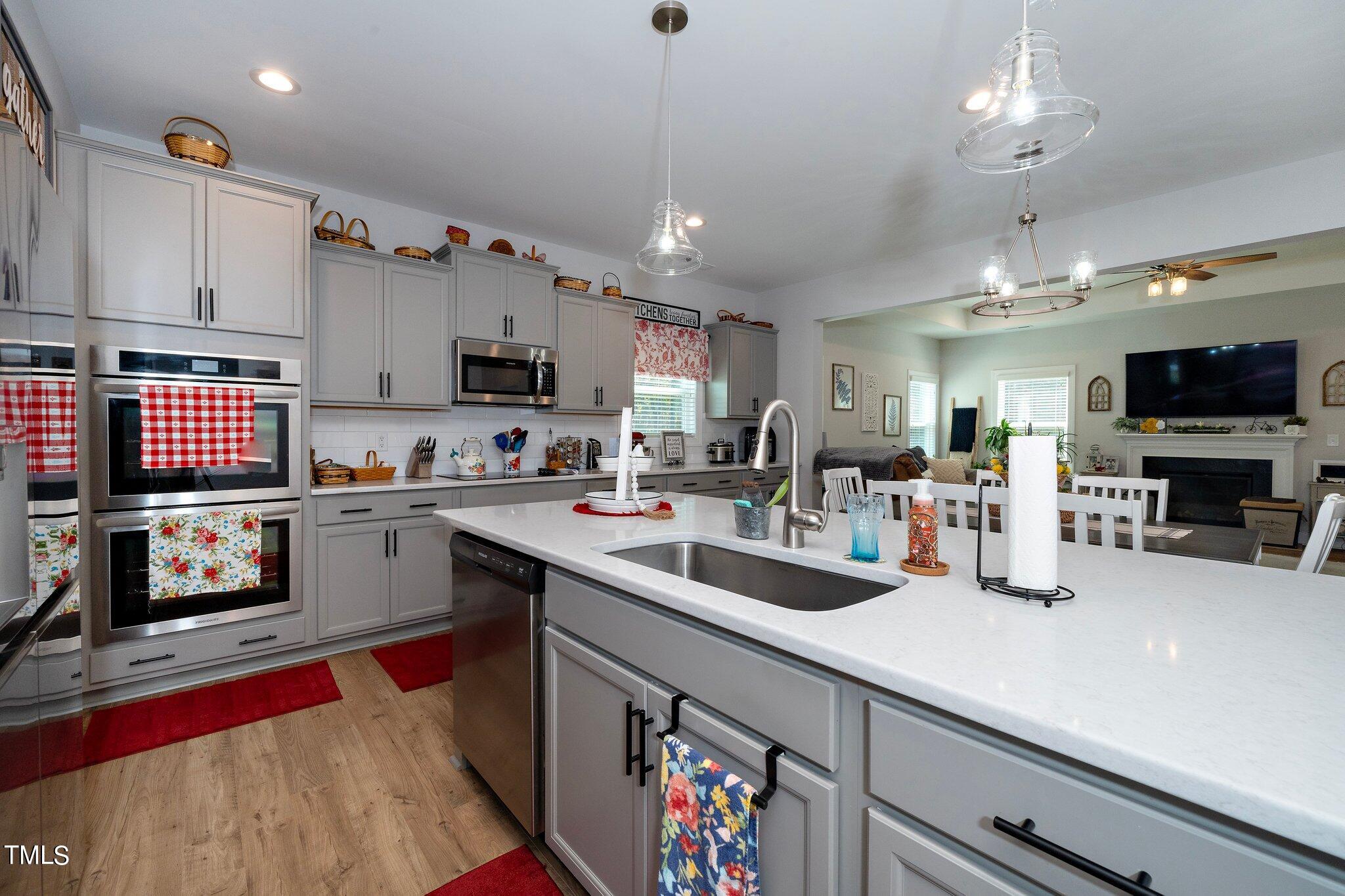 204 Stephens Timberline View Clayton, NC 27520 - Photo 7 of 43 a kitchen with counter top space a sink cabinets and appliances