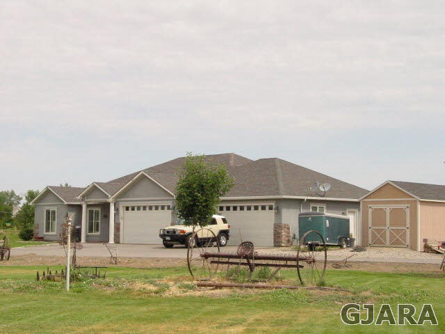 2502 Riata Ranch Road Grand Junction, CO 81505 - Photo 1 of 31 a front view of a house with garden