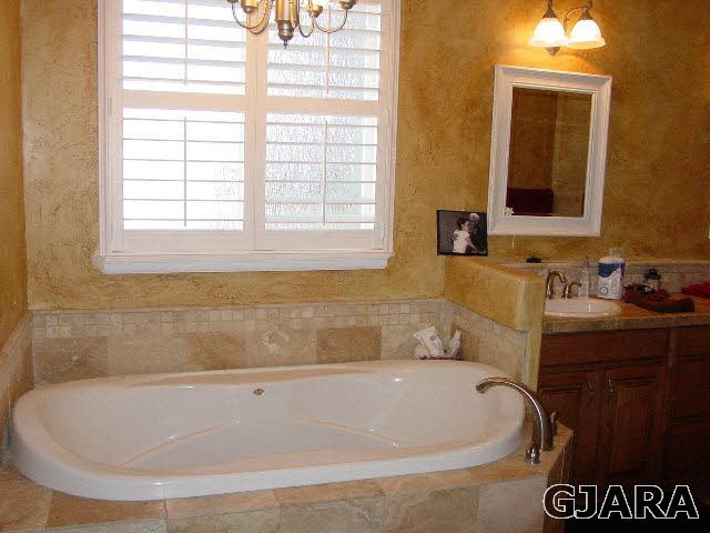 2502 Riata Ranch Road Grand Junction, CO 81505 - Photo 15 of 31 a bath tub sitting in a bathroom next to a window