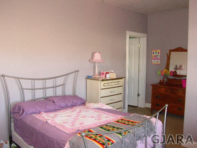 2502 Riata Ranch Road Grand Junction, CO 81505 - Photo 20 of 31 a bedroom with a bed and a dresser in it