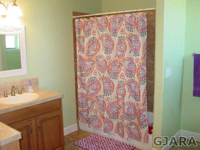 2502 Riata Ranch Road Grand Junction, CO 81505 - Photo 22 of 31 a bathroom with a sink and a mirror