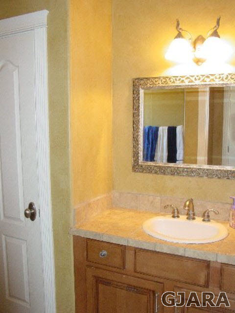 2502 Riata Ranch Road Grand Junction, CO 81505 - Photo 23 of 31 a bathroom with a granite countertop sink and a mirror