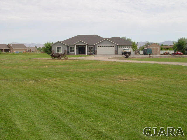 2502 Riata Ranch Road Grand Junction, CO 81505 - Photo 30 of 31 a front view of a house with a garden