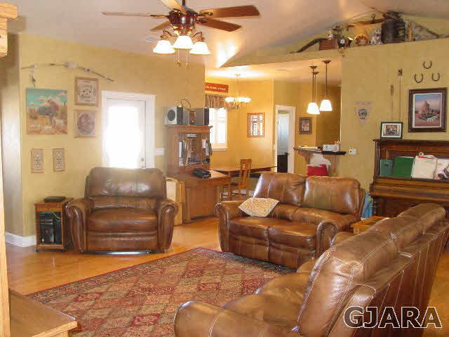 2502 Riata Ranch Road Grand Junction, CO 81505 - Photo 3 of 31 a living room with furniture and a flat screen tv