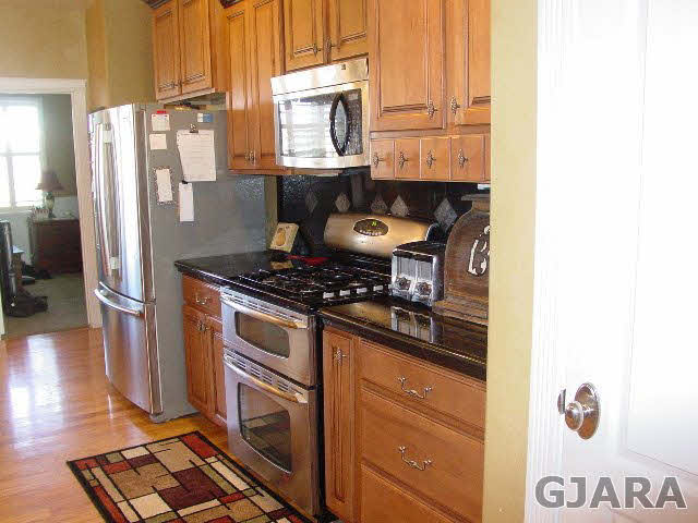 2502 Riata Ranch Road Grand Junction, CO 81505 - Photo 7 of 31 a kitchen with stainless steel appliances granite countertop a stove and a refrigerator
