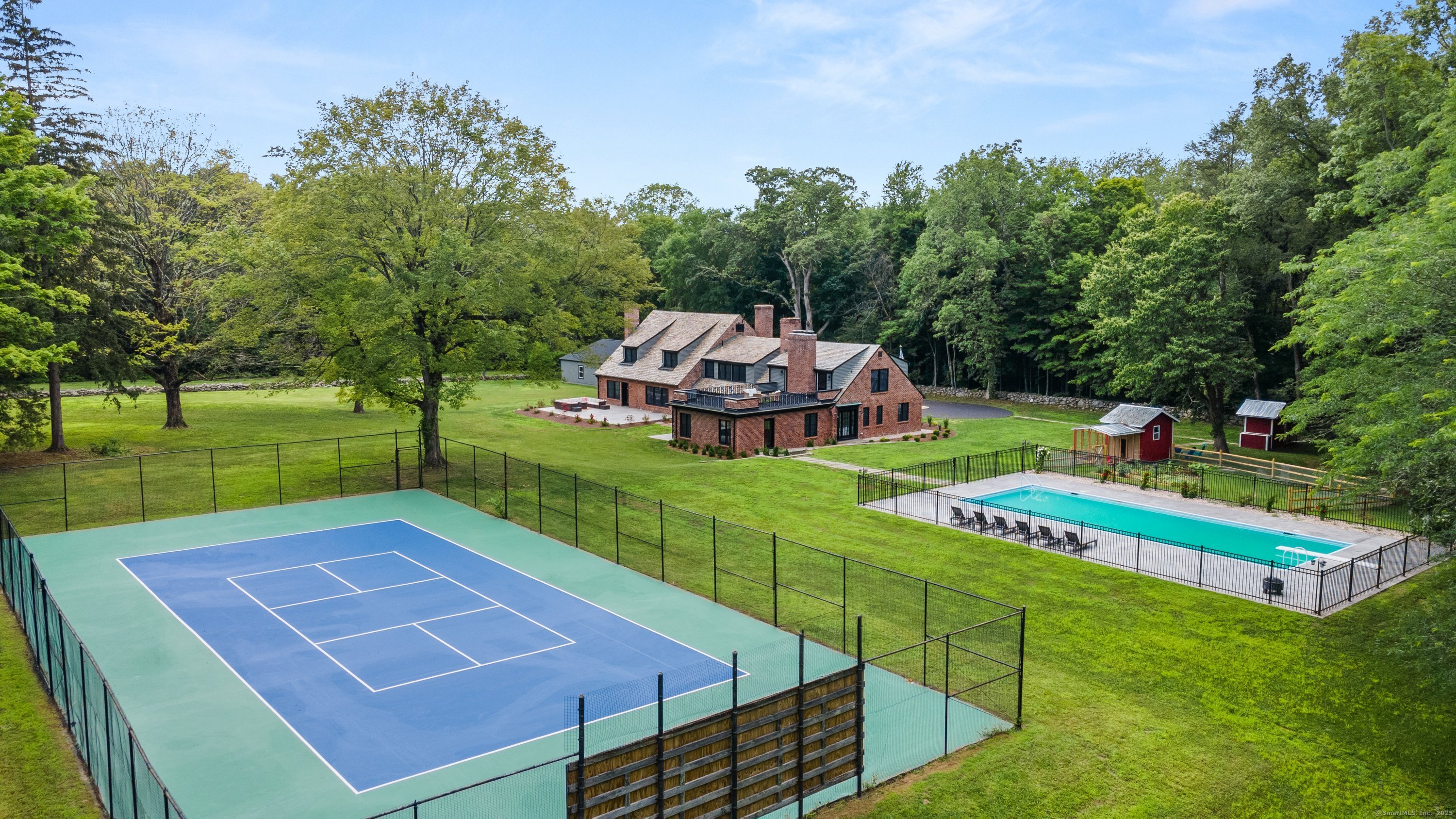 an aerial view of a house with a big yard