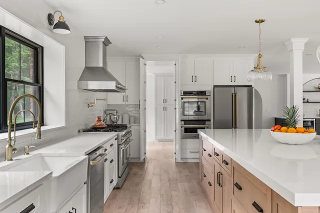 a kitchen with stainless steel appliances a sink stove and refrigerator