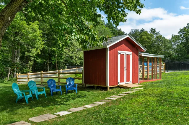 a view of backyard with deck and patio