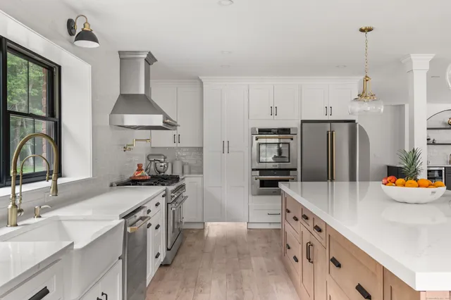 a kitchen with stainless steel appliances a sink stove and refrigerator