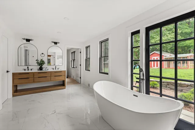 a spacious bathroom with a bathtub and next to a window