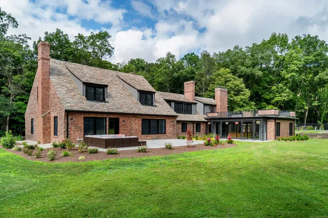 a front view of house with yard and outdoor seating