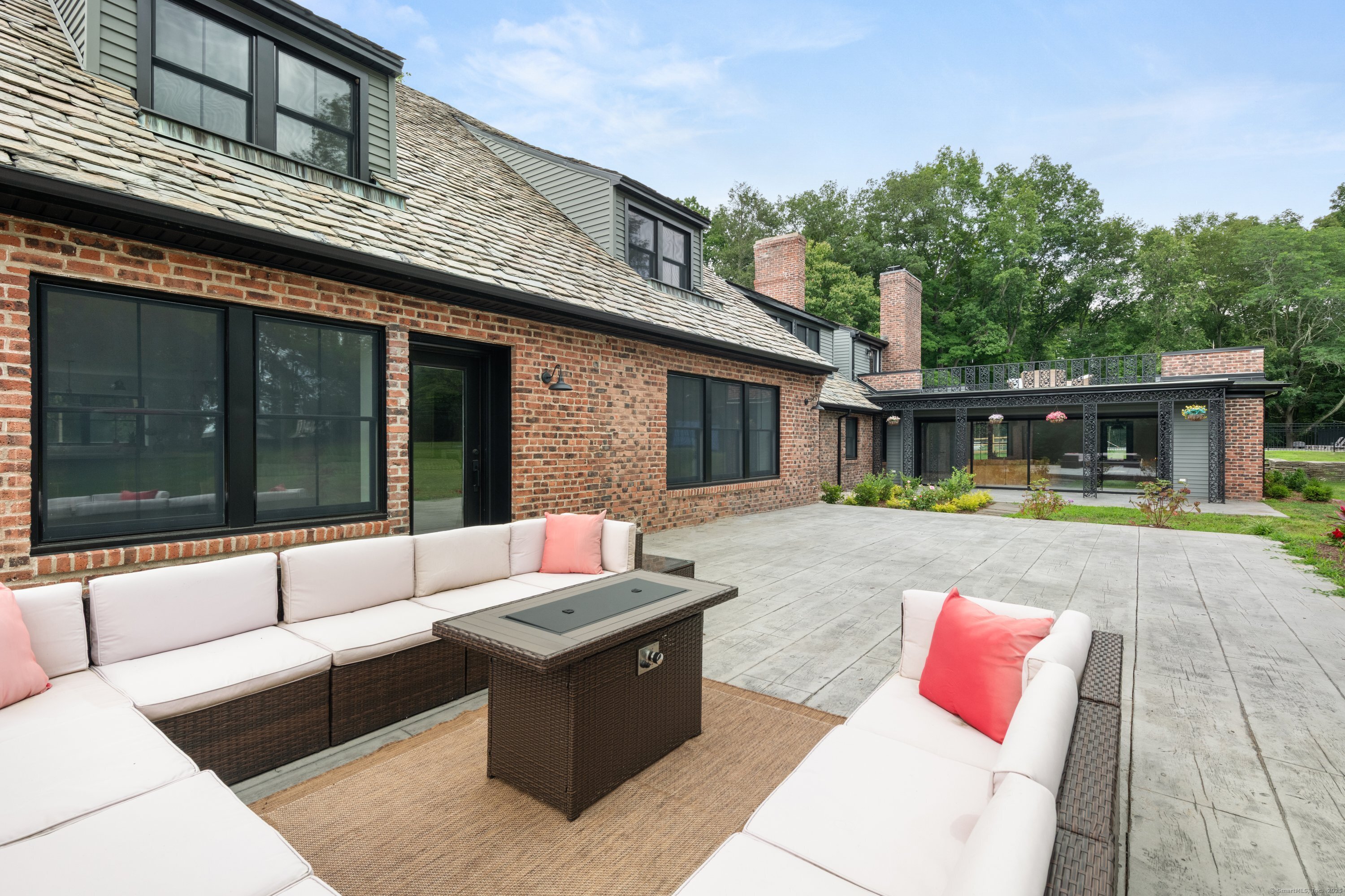 372 Tucker Hill Road Middlebury, CT 06762 - Photo 7 of 33 a view of a patio with couches and a table and chairs with wooden floor