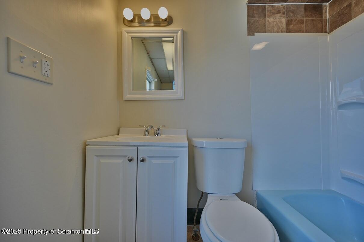1025 Ridge Avenue Scranton, PA 18510 - Photo 32 of 49 a bathroom with a toilet a sink and mirror