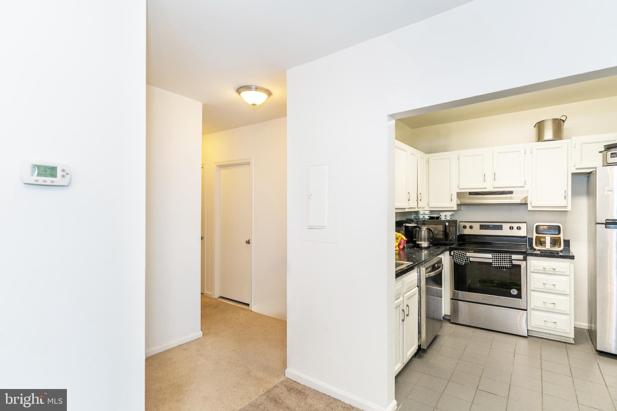 2514 13th Street Northwest Washington, DC 20009 - Photo 6 of 9 a kitchen with stainless steel appliances and white cabinets