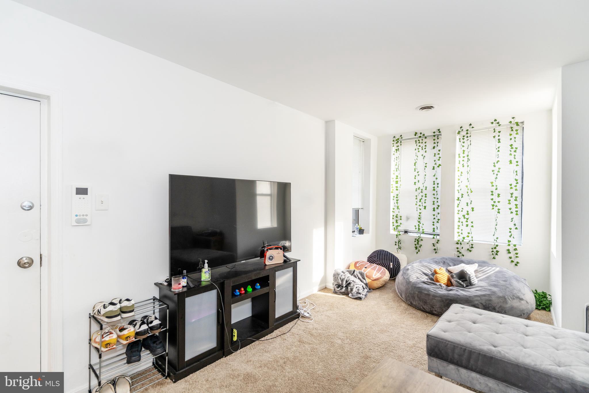 2514 13th Street Northwest Washington, DC 20009 - Photo 7 of 9 a living room with furniture and a flat screen tv