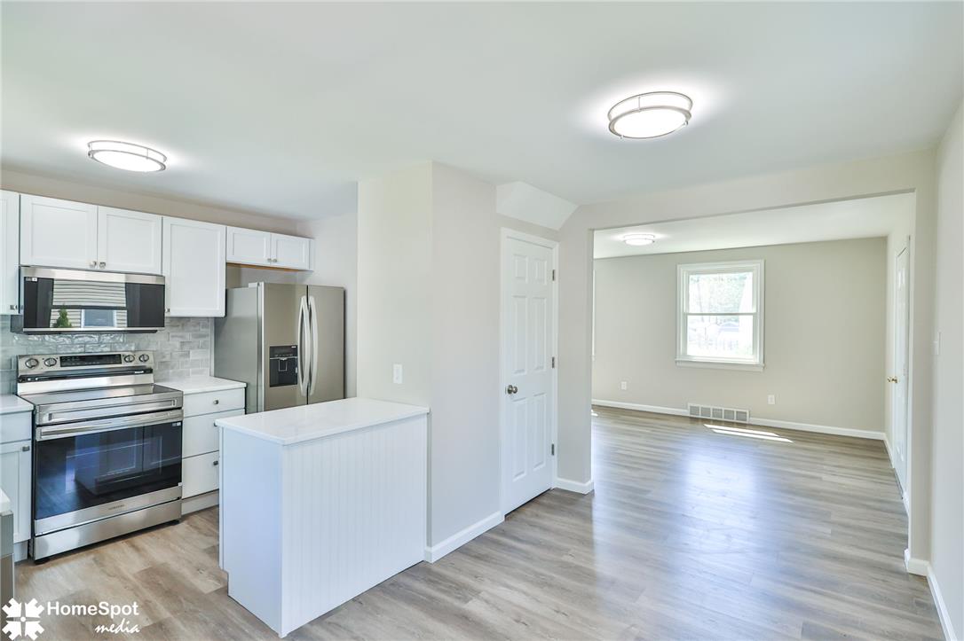 415 Willow Road Hellertown, PA 18055 - Photo 25 of 25 A well-appointed kitchen features stainless steel appliances and an open floor plan flowing into an adjacent living area.