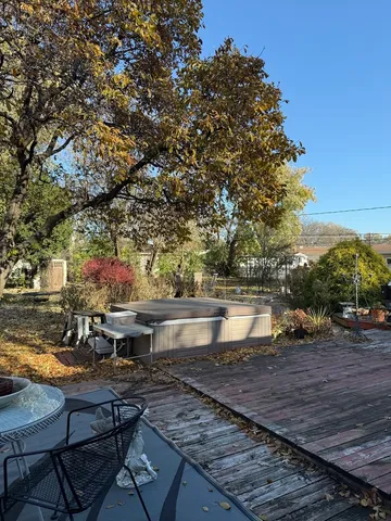 a view of a swimming pool with wooden bench and lake view
